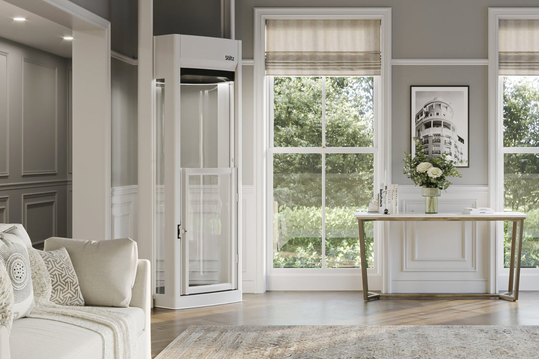 Compact residential home lift installed beside a large window in a modern living space