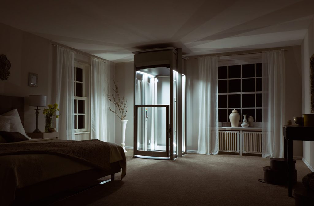 Domestic Home lift, at night time with lift illuminated in bedroom.