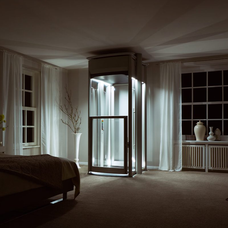 Domestic Home lift, at night time with lift illuminated in bedroom.