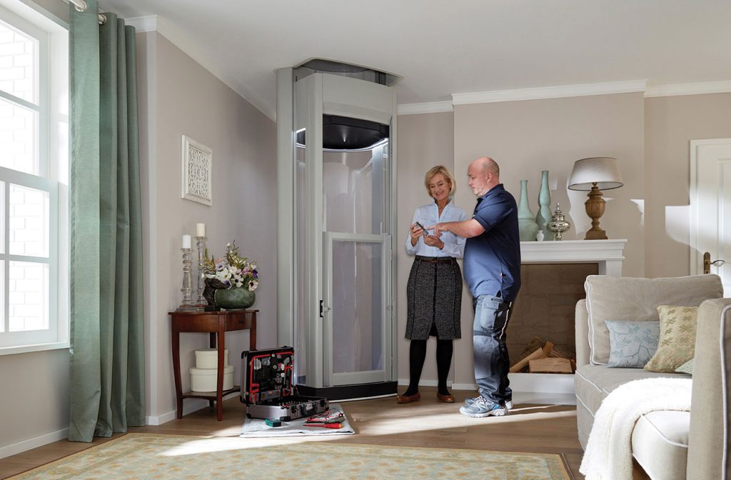 Install Man talking to happy women who has a home lift installed