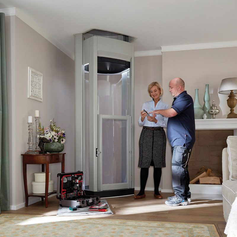 Install Man talking to happy women who has a home lift installed